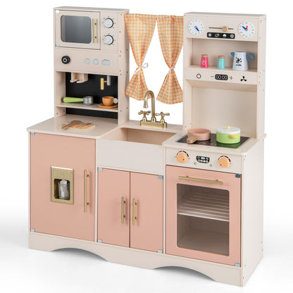 Close-up of the pink wooden play kitchen with microwave, sink, oven, and storage cupboards