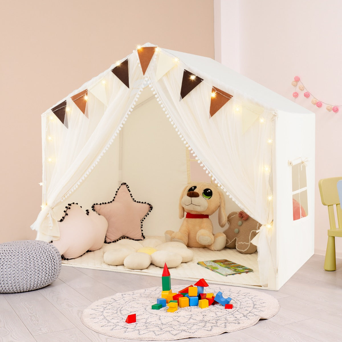 the large play tent house with fabric and screen curtains set up indoors