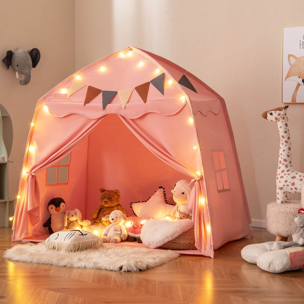 The pink play tent bed with decorative lights and bunting, shown in a child's bedroom