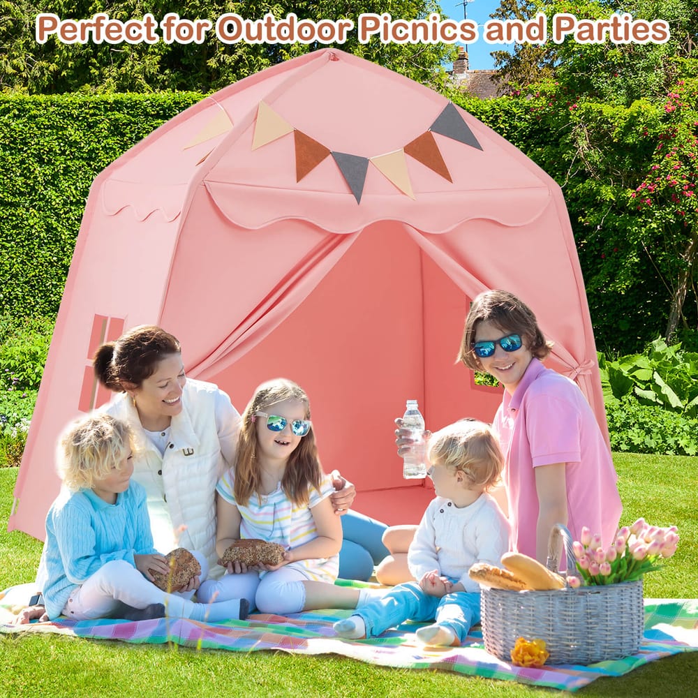 A family enjoying the pink play tent bed outdoors on a sunny day