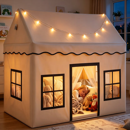 The play tent in a dimly lit room with a child sleeping inside surrounded by plush toys