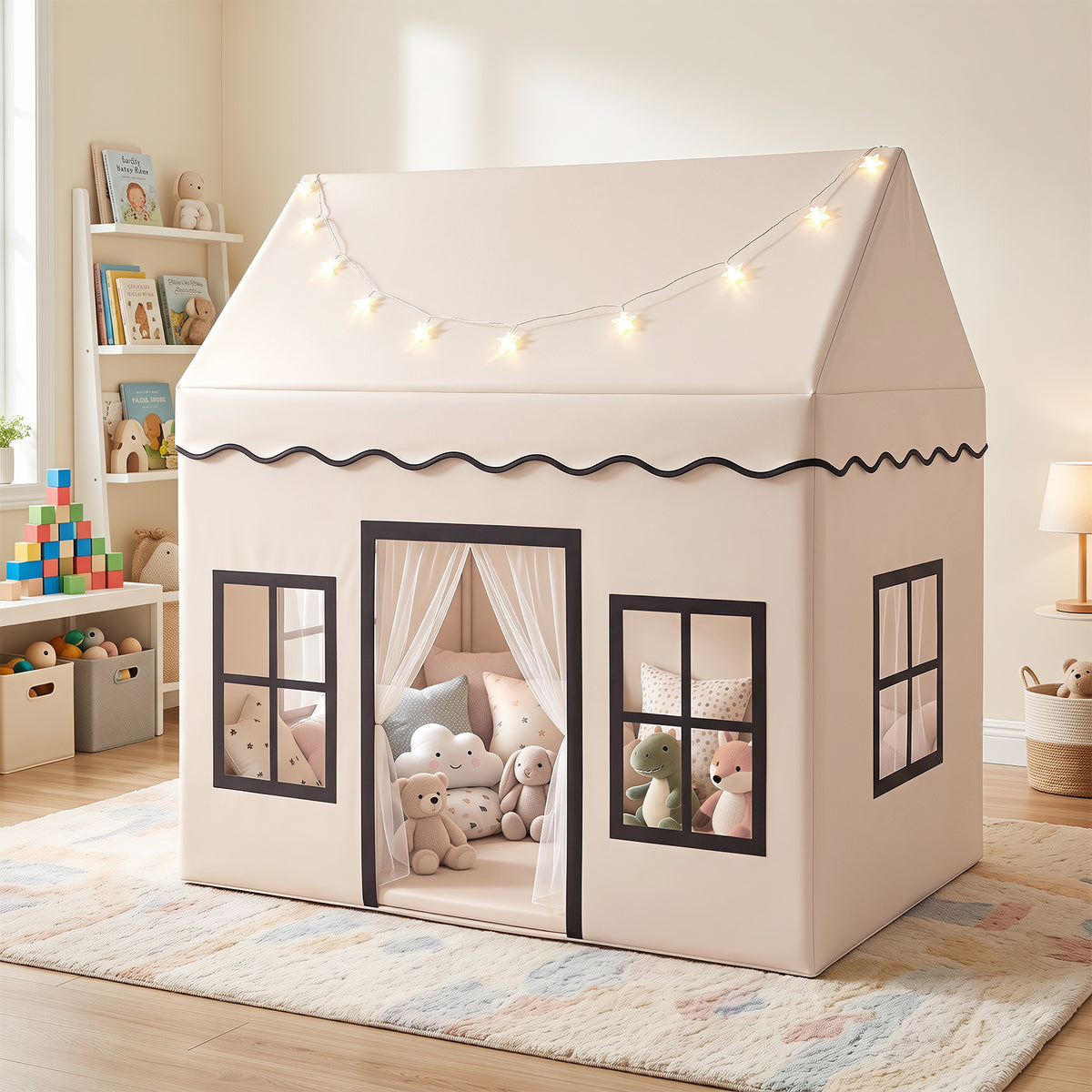 The play tent set up in a bright nursery with soft toys inside and star lights on the roof
