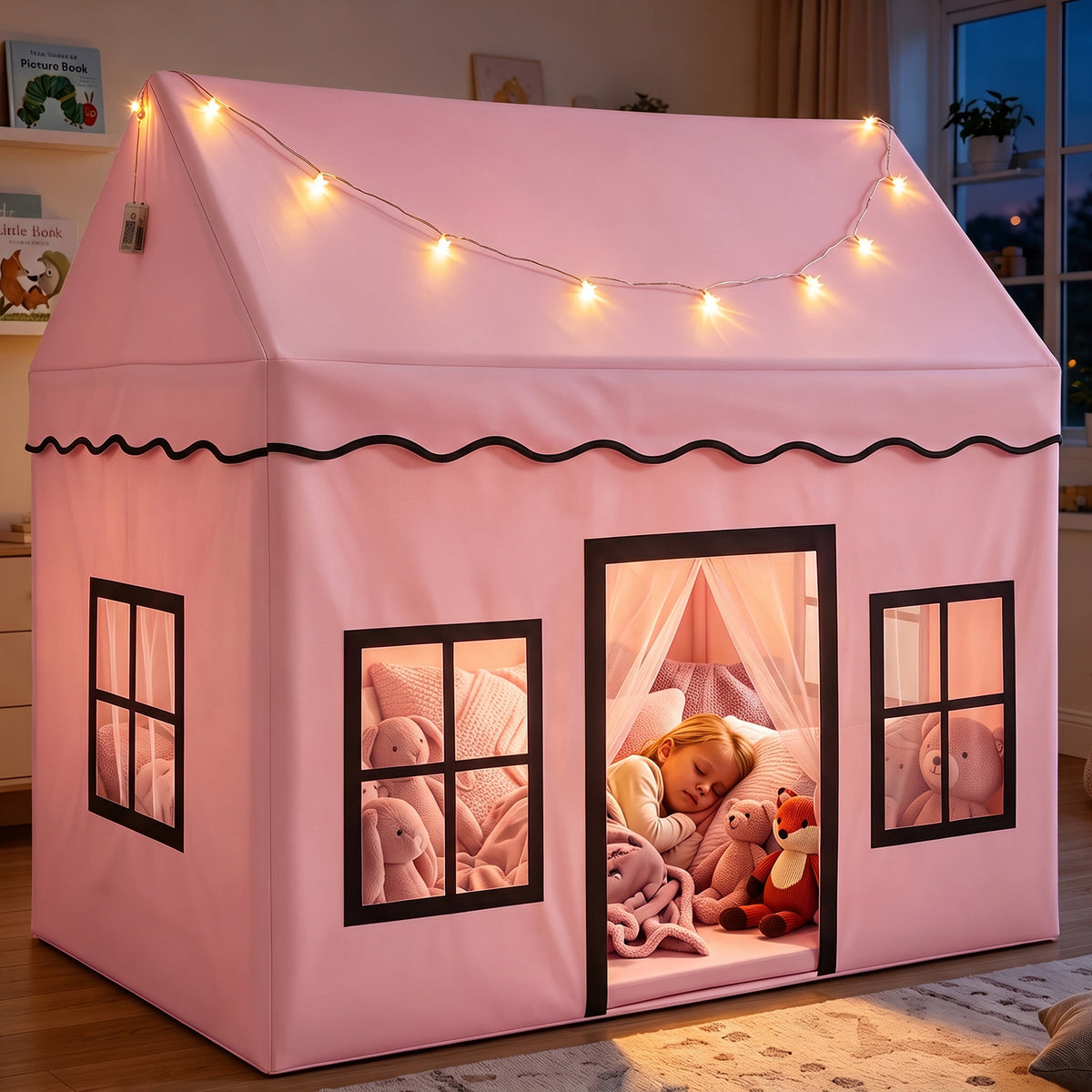 A young child sleeping peacefully inside a pink play tent with star lights and soft toys