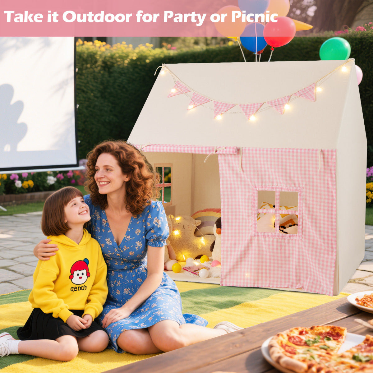 The pink play tent placed on a garden patio for an outdoor party
