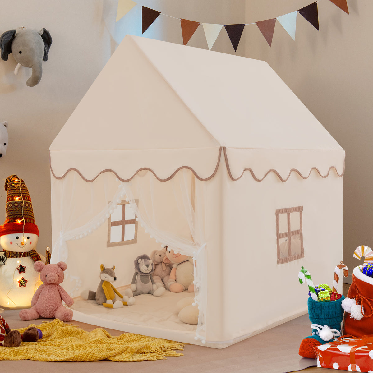 The beige playhouse tent set up indoors with toys and decorations around it