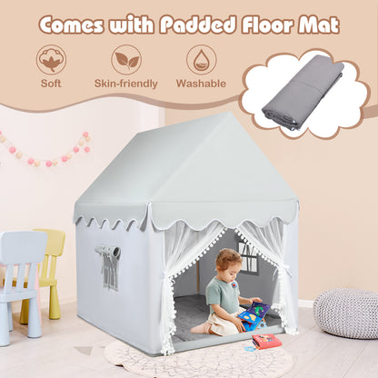 Child playing inside a grey play tent with a padded mat, showing it is washable