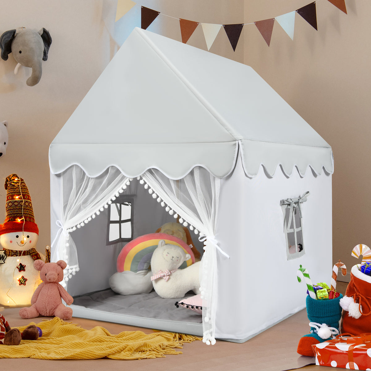 Grey play tent set up indoors with festive decorations and toys around it