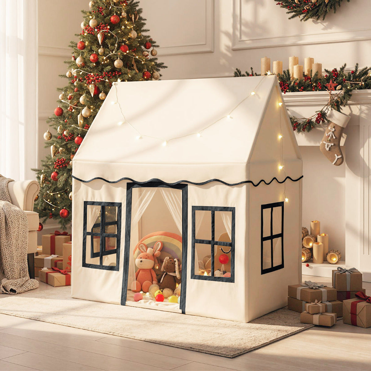 The play tent is set up in a living room next to a Christmas tree and fireplace
