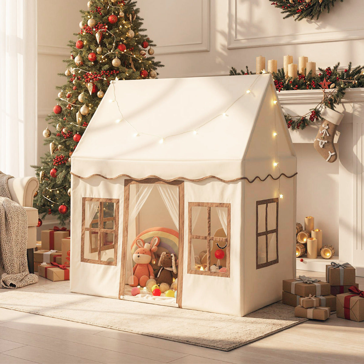 The play tent is set up in a festive room with a Christmas tree and presents