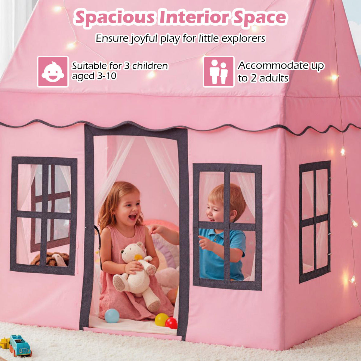 The play tent interior with two children playing inside with their soft toys