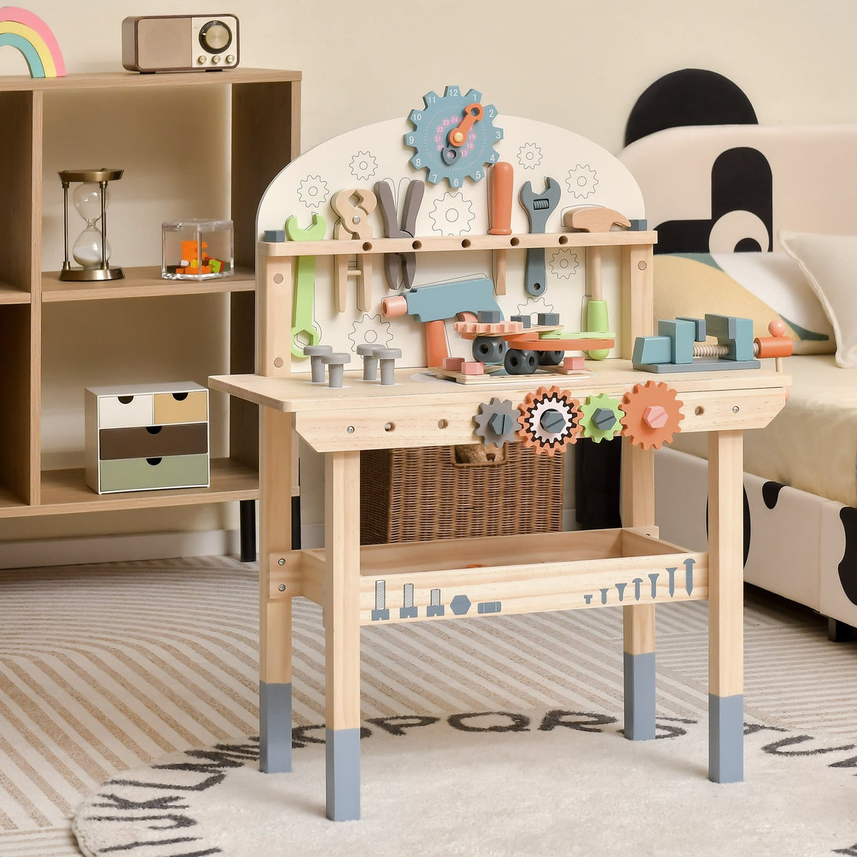 The pretend toy workbench set up in a child's bedroom with toys and furniture