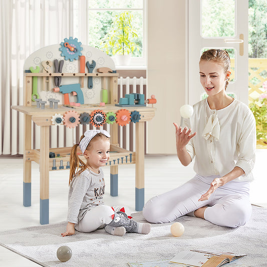 Mother and daughter playing with the pretend toy workbench in a living room setting