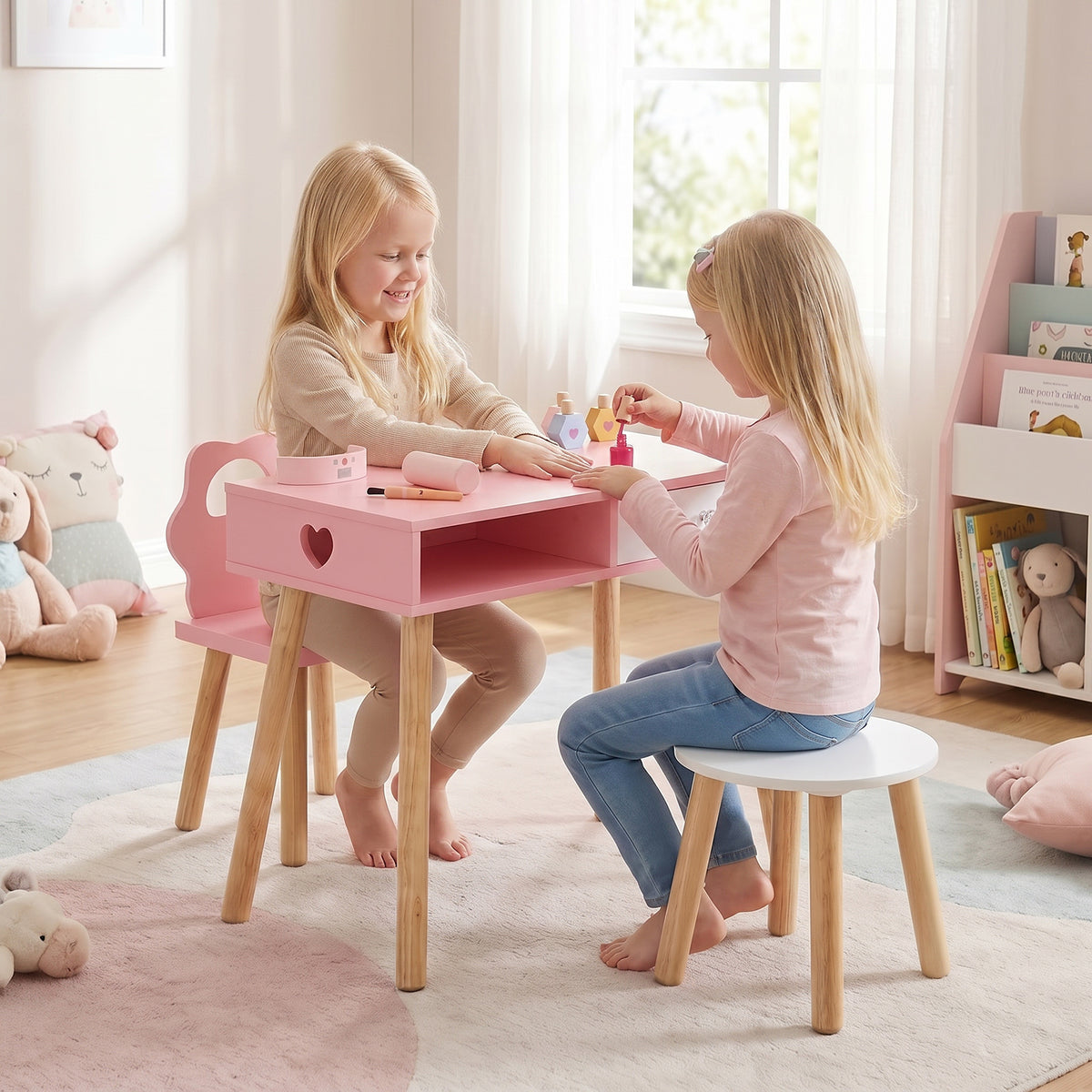 Two young girls sitting at the kids table and chair set playing with wooden beauty accessories