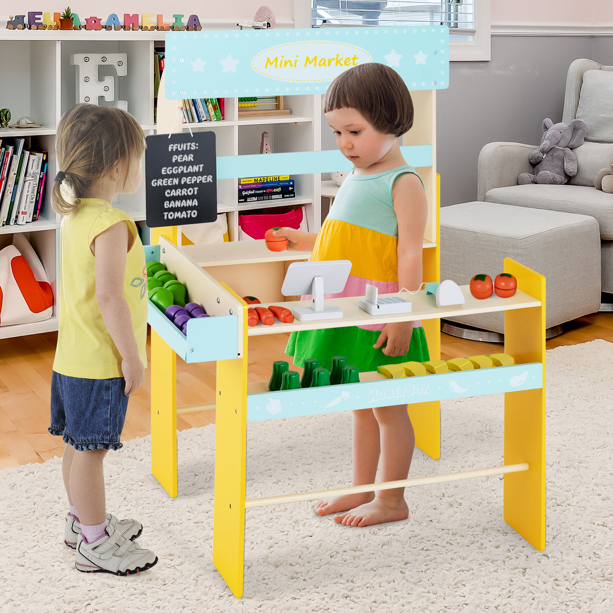 Two children playing at the blue and yellow pretend play grocery store, one serving the other