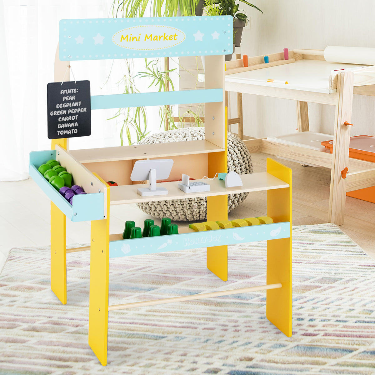 A close-up of the blue and yellow pretend play grocery store, showing the shelves stocked with toy food