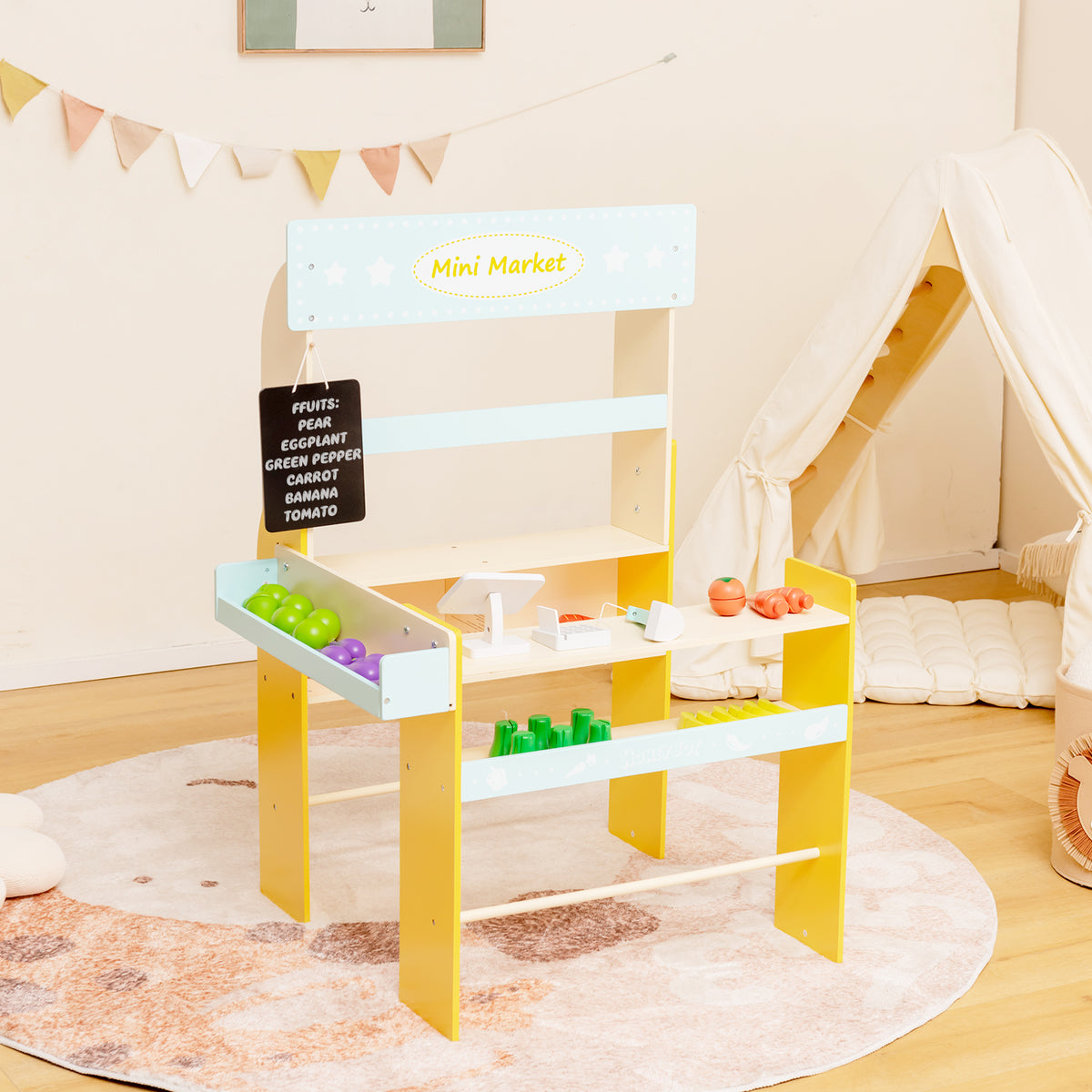 The blue and yellow pretend play grocery store set up in a child's playroom with a tent in the background