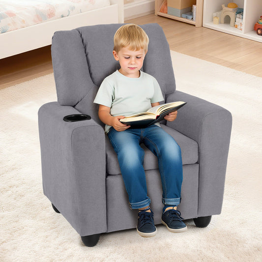 A young boy sits reading a book in the grey kids reclining chair with a cup holder
