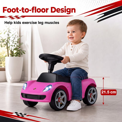 A toddler sitting on the pink sliding car indoors to demonstrate the foot to floor design