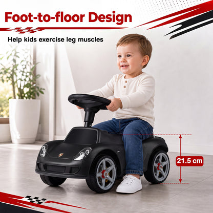 A child sits in the black Porsche style sliding car, showing its foot-to-floor design