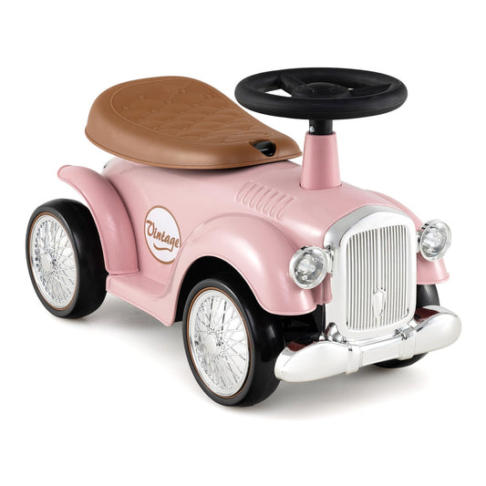 Kids Ride On Car in pink with a brown seat and a black steering wheel