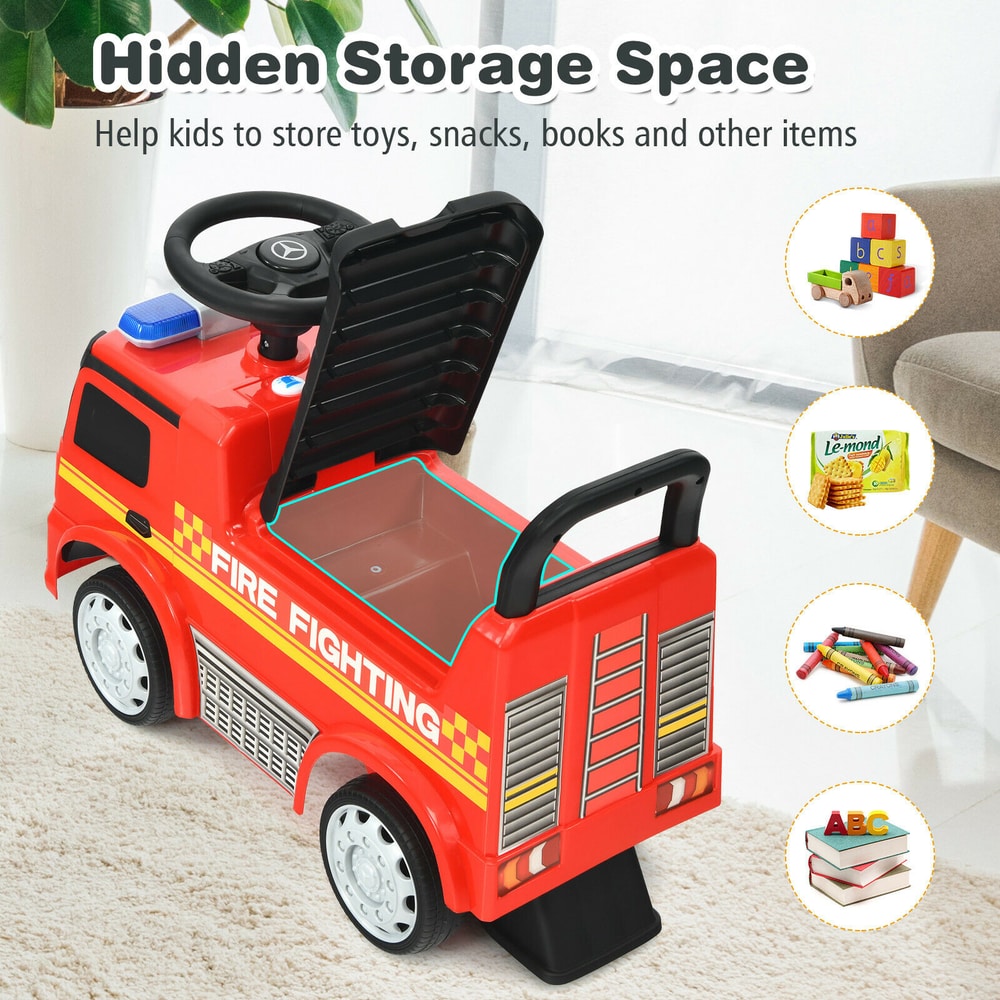 Rear view of the red Mercedes Benz firefighter ride on car with the seat lifted to show storage space