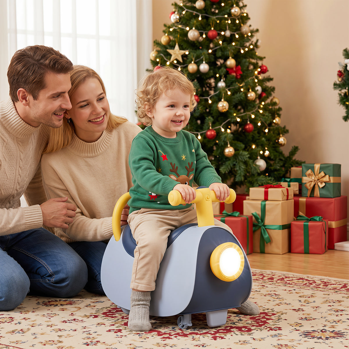 The ride on toy being used by a child in front of a decorated Christmas tree with family