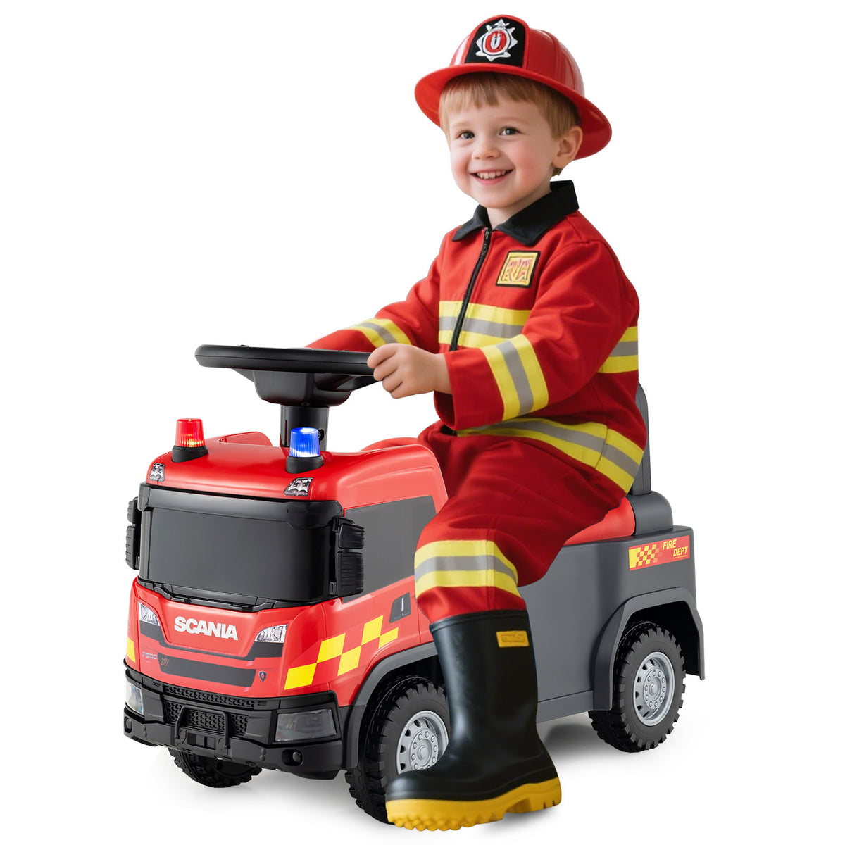 A happy boy in a firefighter costume sits on the red push car, steering it
