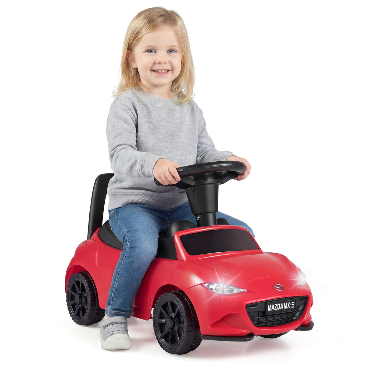 The sliding toy shown from a front angle with a child sitting on the seat