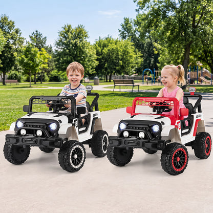 Two children enjoying the red and white electric toy cars in a park setting