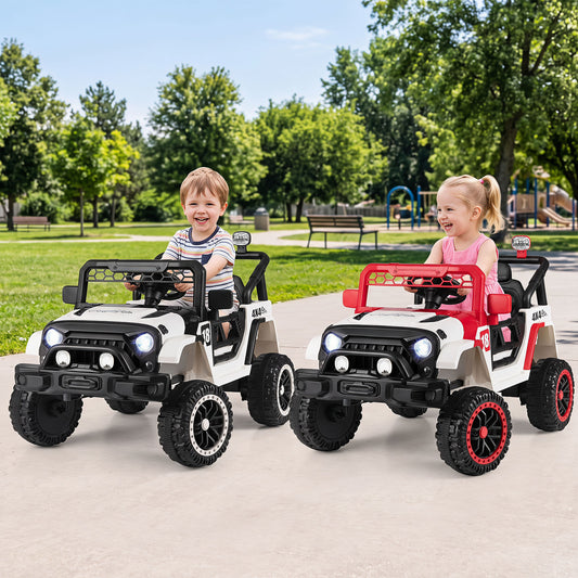 Two children enjoying the red and white electric toy cars in a park setting