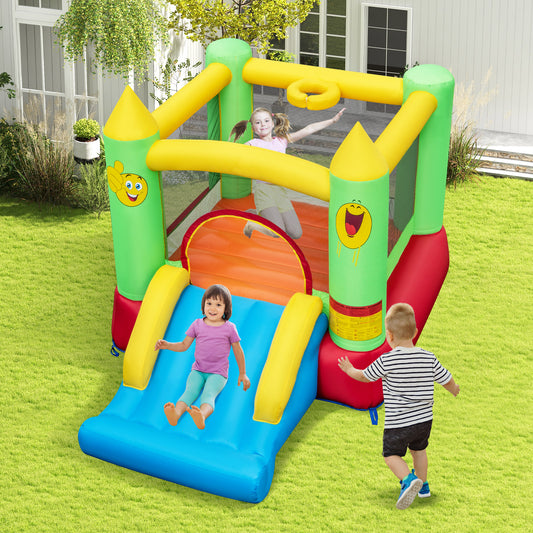 The bouncy castle in a garden with children jumping and sliding on the inflatable structure