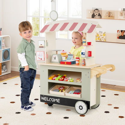 The play kitchen set being used by two children playing together in a bright indoor playroom