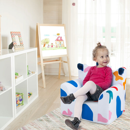 A happy toddler sits on the colourful kids armchair in a bright playroom