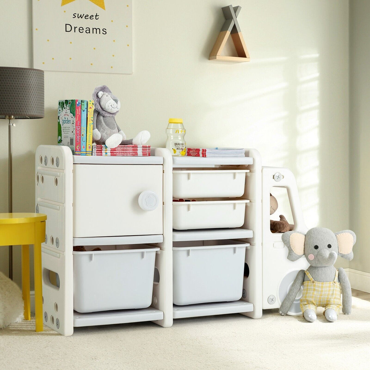 Kids storage unit in a nursery room, decorated with stuffed animals and children's books