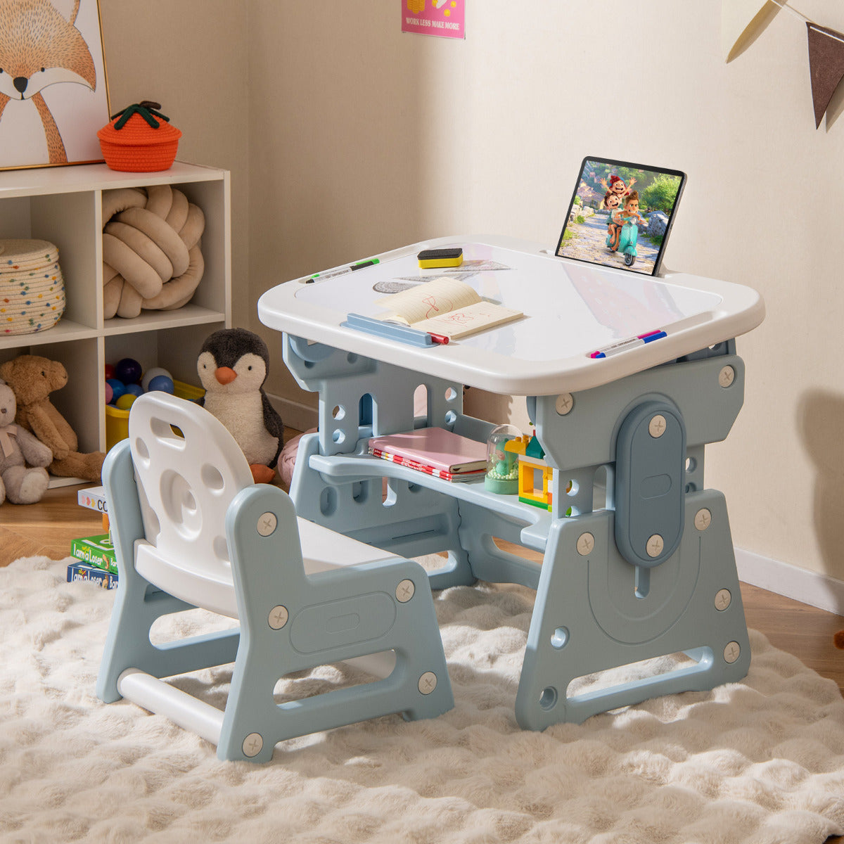 The blue kids table and chair set is shown in a child's bedroom setting