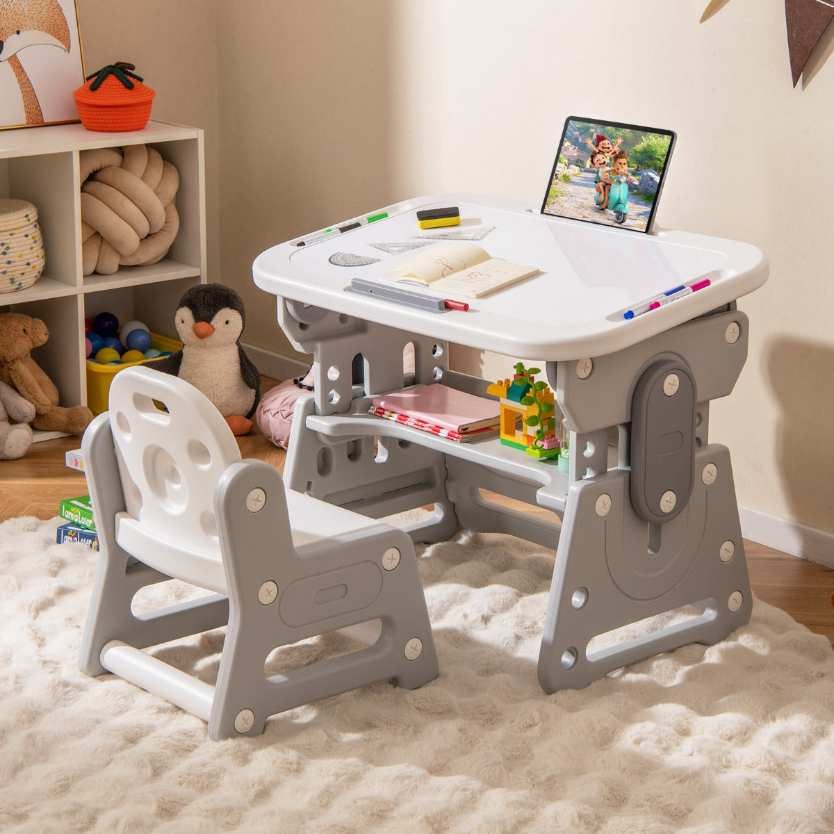 The kids table and chair set placed on a fluffy rug in a child's bedroom with toys nearby