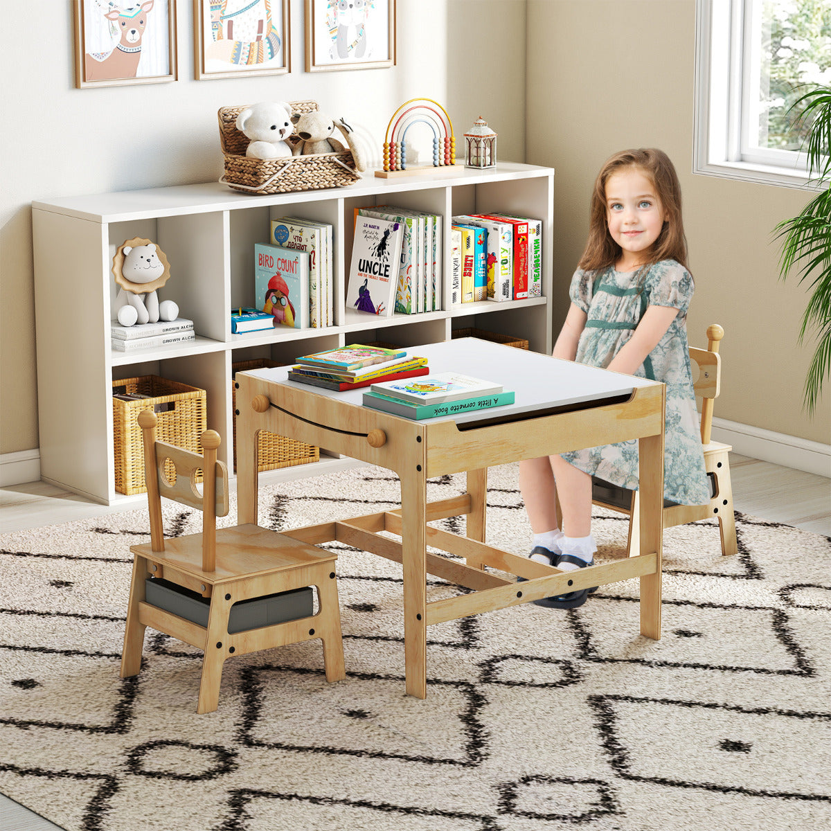 The activity desk set in a child's bedroom with a young girl sitting at the table
