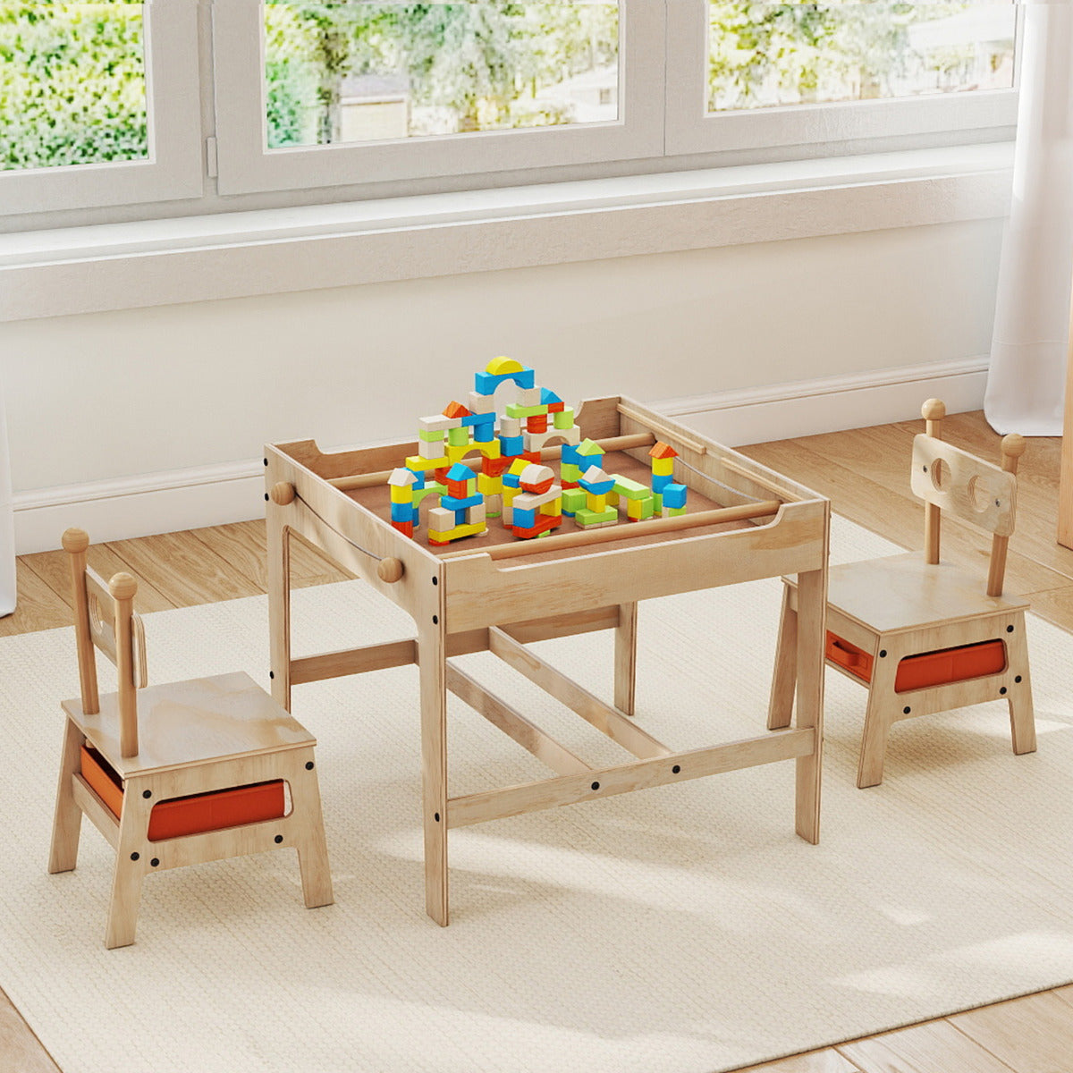 The wooden activity desk and chairs are set up with colourful building blocks on the table surface