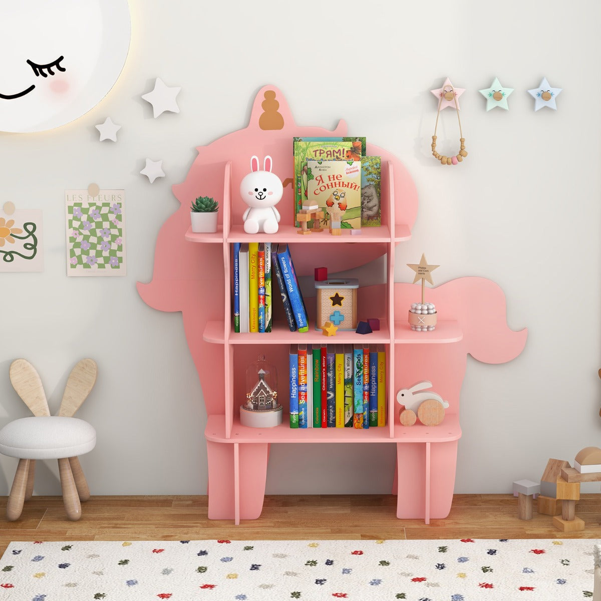 The pink unicorn storage unit filled with children's books and toys in a nursery