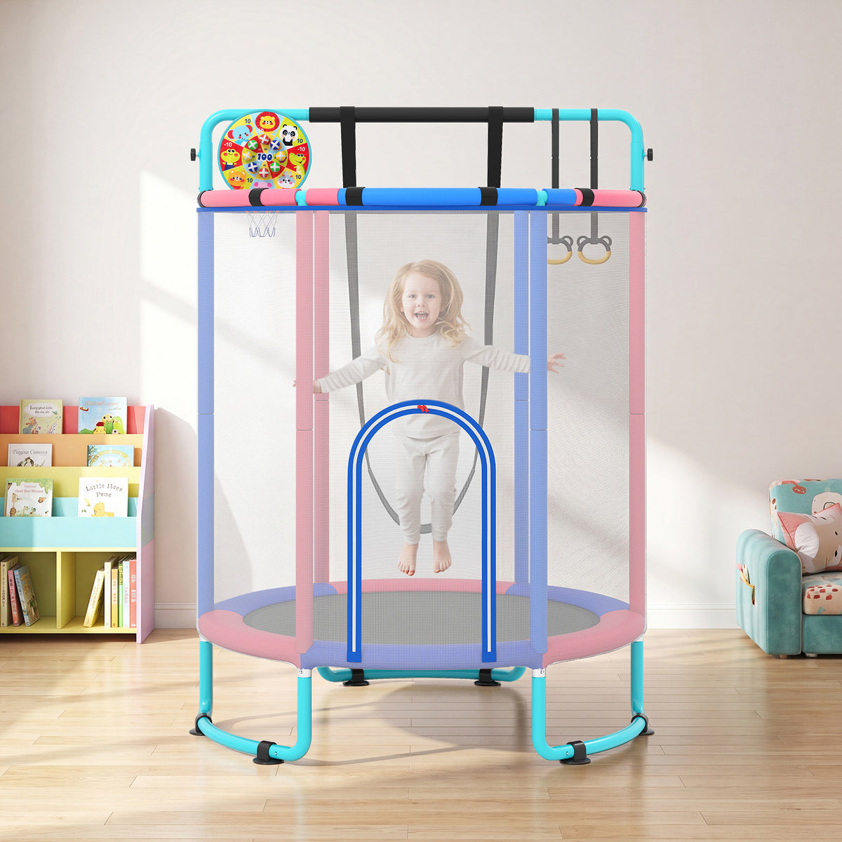 Blue and pink kids trampoline with safety net and hanging rings, set up indoors