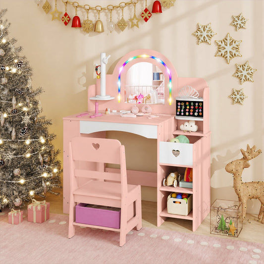 Pink kids vanity desk with mirror lights and chair set up in a festive room