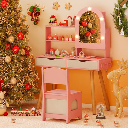 Pink dressing table and chair set in a festive room with a Christmas tree