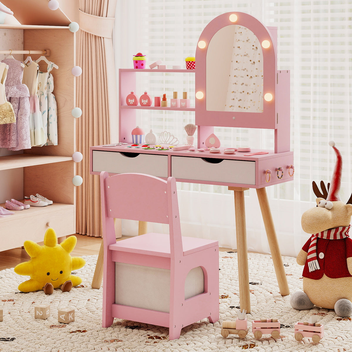 Pink dressing table and chair set in a child's bedroom with toys and clothes