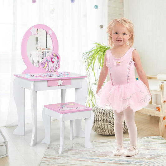 A young girl in a pink tutu stands next to the kids vanity table and chair set in a room