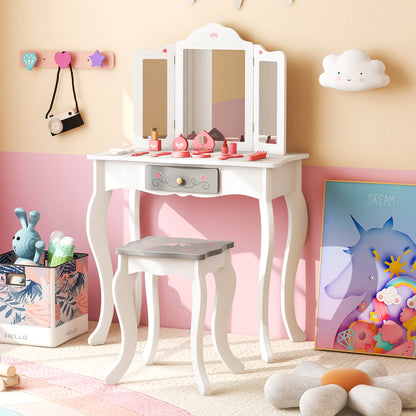 The kids vanity set positioned in a playroom next to a unicorn picture and toy storage