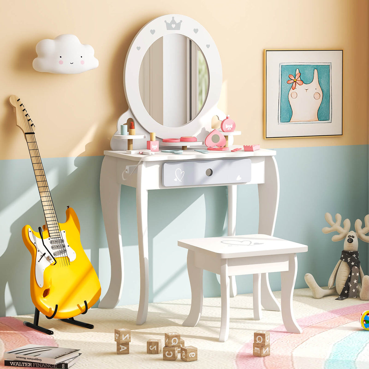 The white dressing table and stool set in a child's room with a guitar and toys