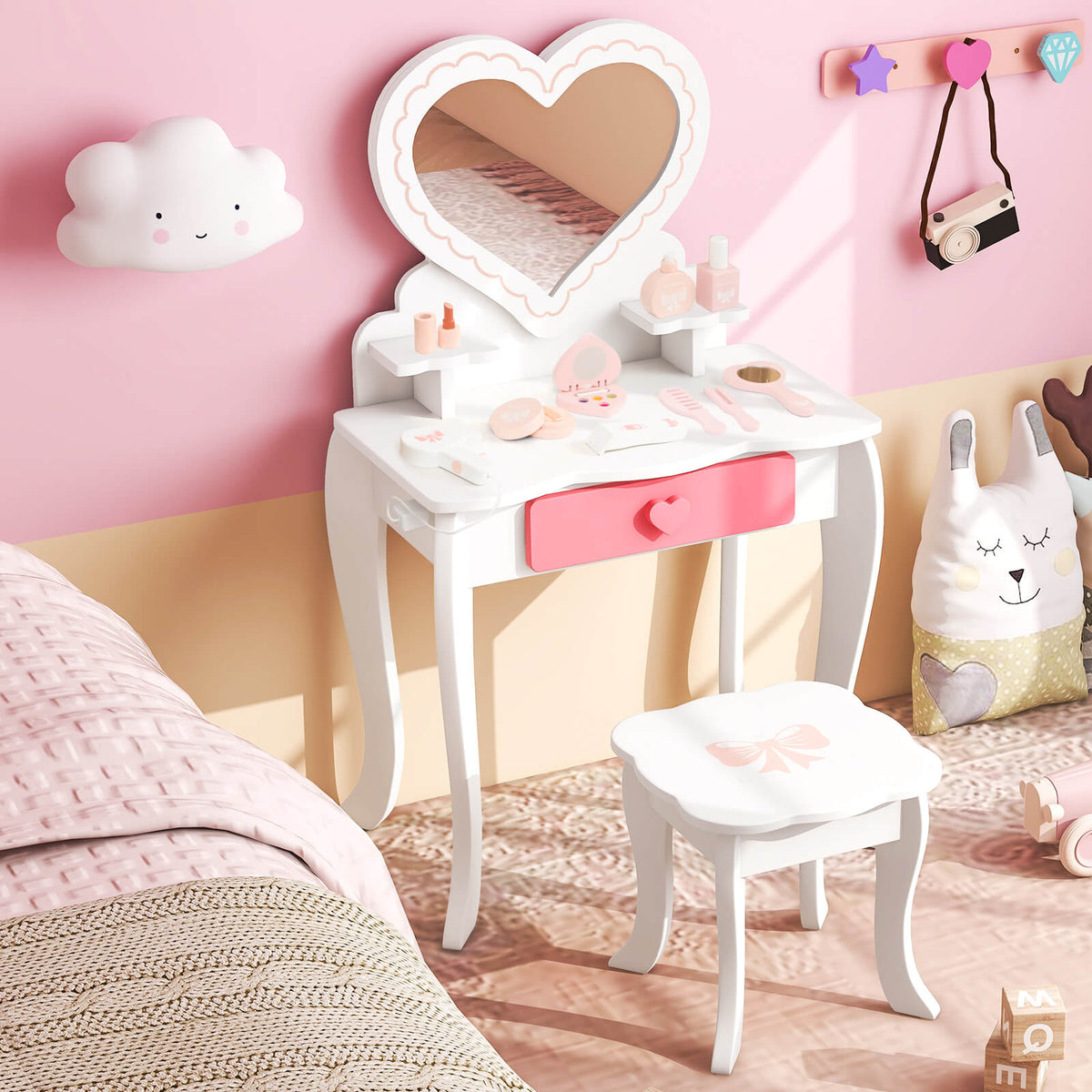 White kids vanity table and stool with heart shaped mirror, set up in a child's bedroom