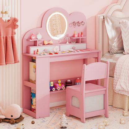 The pink princess vanity table and chair set in a bedroom with a bed in the background