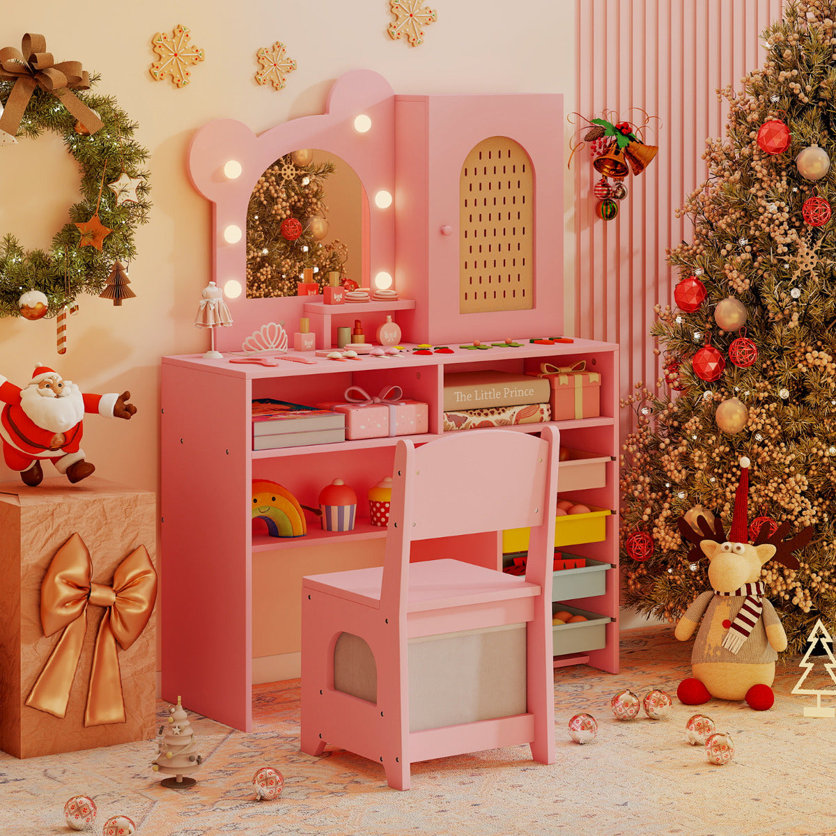The pink dressing table with lights and chair set up in a festive room with a Christmas tree