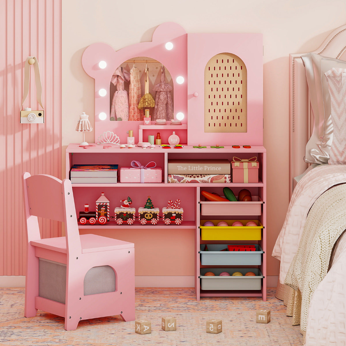 The pink dressing table with lights and chair, with toys and accessories on the surface